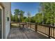 Wooden deck featuring a table and chairs overlooking a lush green space at 19 Four Feathers Ne Ln, Rydal, GA 30171