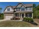 Stunning two-story home with a covered front porch, manicured lawn, and an attached garage, perfect for Gathering living at 19 Four Feathers Ne Ln, Rydal, GA 30171