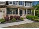 Inviting front porch with stone accents and tasteful landscaping welcomes you home at 19 Four Feathers Ne Ln, Rydal, GA 30171