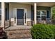 Charming covered porch with stone accents and rocking chairs offer a welcoming entrance at 19 Four Feathers Ne Ln, Rydal, GA 30171