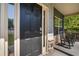 Charming front porch with rocking chairs, a stylish front door, and durable stone accents at 19 Four Feathers Ne Ln, Rydal, GA 30171
