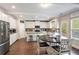 Bright kitchen features white cabinets, stainless appliances, granite counters, and an eat-in area at 19 Four Feathers Ne Ln, Rydal, GA 30171