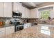 Modern kitchen with granite countertops, stainless steel appliances and ample cabinet space at 19 Four Feathers Ne Ln, Rydal, GA 30171