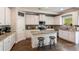Well-equipped kitchen featuring white cabinets, granite counters, an island, and modern appliances at 19 Four Feathers Ne Ln, Rydal, GA 30171
