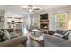Open-concept living room featuring a stone fireplace, hardwood floors and great natural light at 19 Four Feathers Ne Ln, Rydal, GA 30171