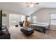 Spacious main bedroom with a vaulted ceiling, plush carpet, and a cozy sitting area by bright windows at 19 Four Feathers Ne Ln, Rydal, GA 30171