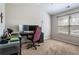 Office room featuring carpet floors, a large window providing natural light, and a desk setup for a productive work environment at 19 Four Feathers Ne Ln, Rydal, GA 30171