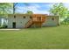 Exterior rear view featuring a wooden deck, stairs, and large yard at 2793 Horse Shoe Dr, Atlanta, GA 30316
