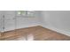 A bright bedroom showcasing gleaming hardwood floors and fresh paint at 2793 Horse Shoe Dr, Atlanta, GA 30316