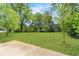 Expansive green front yard with healthy grass and mature trees, leading to a peaceful home at 2793 Horse Shoe Dr, Atlanta, GA 30316