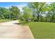 Lush front yard with mature trees and a long driveway leading up to the charming home at 2793 Horse Shoe Dr, Atlanta, GA 30316