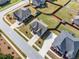 Aerial view showcasing backyard with green grass, privacy fence, and neighborhood at 4689 Shire Dr, Lithonia, GA 30038