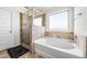 Bathroom with soaking tub, shower, and tile surround at 4689 Shire Dr, Lithonia, GA 30038