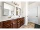 Bathroom featuring double vanity with granite counters and wooden cabinets at 4689 Shire Dr, Lithonia, GA 30038