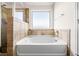 Bright bathroom showcasing tiled tub-shower combination and large window at 4689 Shire Dr, Lithonia, GA 30038