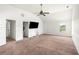 Spacious bonus room with neutral carpet, ceiling fan, and natural light at 4689 Shire Dr, Lithonia, GA 30038