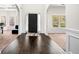 Elegant entryway with hardwood floors, archway, and wainscoting leading into rooms with lots of natural light at 4689 Shire Dr, Lithonia, GA 30038