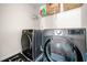 Laundry area equipped with modern gray LG washer and dryer units and shelving at 4689 Shire Dr, Lithonia, GA 30038
