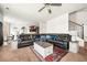 Open-concept living area flows into kitchen; features a large sectional sofa and stairs at 4689 Shire Dr, Lithonia, GA 30038