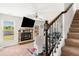 Carpeted living room showcases fireplace, staircase, and neutral decor at 4689 Shire Dr, Lithonia, GA 30038