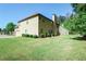 Spacious backyard view featuring a well-maintained lawn and mature trees surrounding the property at 1544 English Manor Cir, Stone Mountain, GA 30087