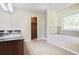 Modern bathroom featuring double sinks, granite countertop, soaking tub, and separate shower at 1544 English Manor Cir, Stone Mountain, GA 30087