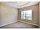 Cozy bedroom featuring neutral tones, plush carpet, and ample natural light through a large window at 1544 English Manor Cir, Stone Mountain, GA 30087