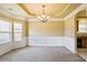 Elegant dining room with decorative molding, chandelier, and natural light from bay window at 1544 English Manor Cir, Stone Mountain, GA 30087