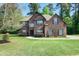 Charming two-story brick home with manicured lawn and mature trees in a desirable neighborhood at 1544 English Manor Cir, Stone Mountain, GA 30087