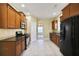 Well-equipped kitchen with stainless steel appliances, granite countertops, and tile flooring at 1544 English Manor Cir, Stone Mountain, GA 30087