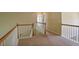 Landing featuring carpet floors and wooden railings, offering a cozy transition between levels at 1544 English Manor Cir, Stone Mountain, GA 30087