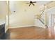 Open-concept living room with hardwood floors, staircase, and a cozy fireplace at 1544 English Manor Cir, Stone Mountain, GA 30087