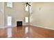 Spacious living room with hardwood flooring, a fireplace, and tall windows for ample lighting at 1544 English Manor Cir, Stone Mountain, GA 30087