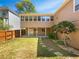 Well-manicured backyard with a lush lawn, privacy fence and a covered patio for outdoor enjoyment at 1704 Golf Link Dr, Stone Mountain, GA 30088
