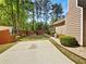 Private backyard featuring a concrete patio, lush landscaping, and a fenced-in yard for outdoor enjoyment at 1704 Golf Link Dr, Stone Mountain, GA 30088
