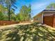 Expansive backyard with a well-maintained lawn, framed by a wooden fence and mature trees for privacy and space at 1704 Golf Link Dr, Stone Mountain, GA 30088