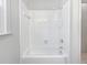 This features a standard tiled bathtub with shower head and sleek white fixtures at 1704 Golf Link Dr, Stone Mountain, GA 30088