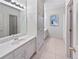 This bathroom has a large mirror, tiled floors, and a vanity with sink at 1704 Golf Link Dr, Stone Mountain, GA 30088