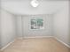 A well-lit bedroom offers a blank canvas with neutral walls and a window overlooking the outdoors at 1704 Golf Link Dr, Stone Mountain, GA 30088