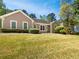 Charming single-story home with a manicured lawn and well-maintained landscaping showcasing beautiful curb appeal at 1704 Golf Link Dr, Stone Mountain, GA 30088