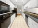 Modern kitchen with white cabinets, stainless steel appliances and a granite countertop at 1704 Golf Link Dr, Stone Mountain, GA 30088