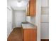 A convenient kitchenette area with wooden cabinets, granite countertop, and tile flooring at 1704 Golf Link Dr, Stone Mountain, GA 30088
