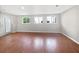 Spacious and bright living room featuring hardwood floors and a walk-out door at 1704 Golf Link Dr, Stone Mountain, GA 30088