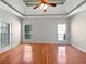 Spacious main bedroom with hardwood floors, tray ceiling, ceiling fan and lots of natural light at 1704 Golf Link Dr, Stone Mountain, GA 30088