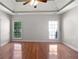 Spacious main bedroom with hardwood floors, tray ceiling, ceiling fan and lots of natural light at 1704 Golf Link Dr, Stone Mountain, GA 30088