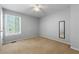 Bedroom featuring light grey walls, carpeted floors and natural light from a large window at 3923 Lookout Point Dr, Marietta, GA 30066
