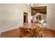 Dining room with wood table and chairs, opening to carpeted living room with wood beamed ceiling at 3923 Lookout Point Dr, Marietta, GA 30066