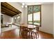Sunlit dining area with hardwood floors, large windows, and wood beam ceiling at 3923 Lookout Point Dr, Marietta, GA 30066
