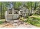 Charming two-story house with a two-car garage nestled among lush trees in a beautiful landscape at 3923 Lookout Point Dr, Marietta, GA 30066
