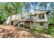 Back exterior view of home featuring an upper wooden deck with stairs and wooded backyard at 3923 Lookout Point Dr, Marietta, GA 30066